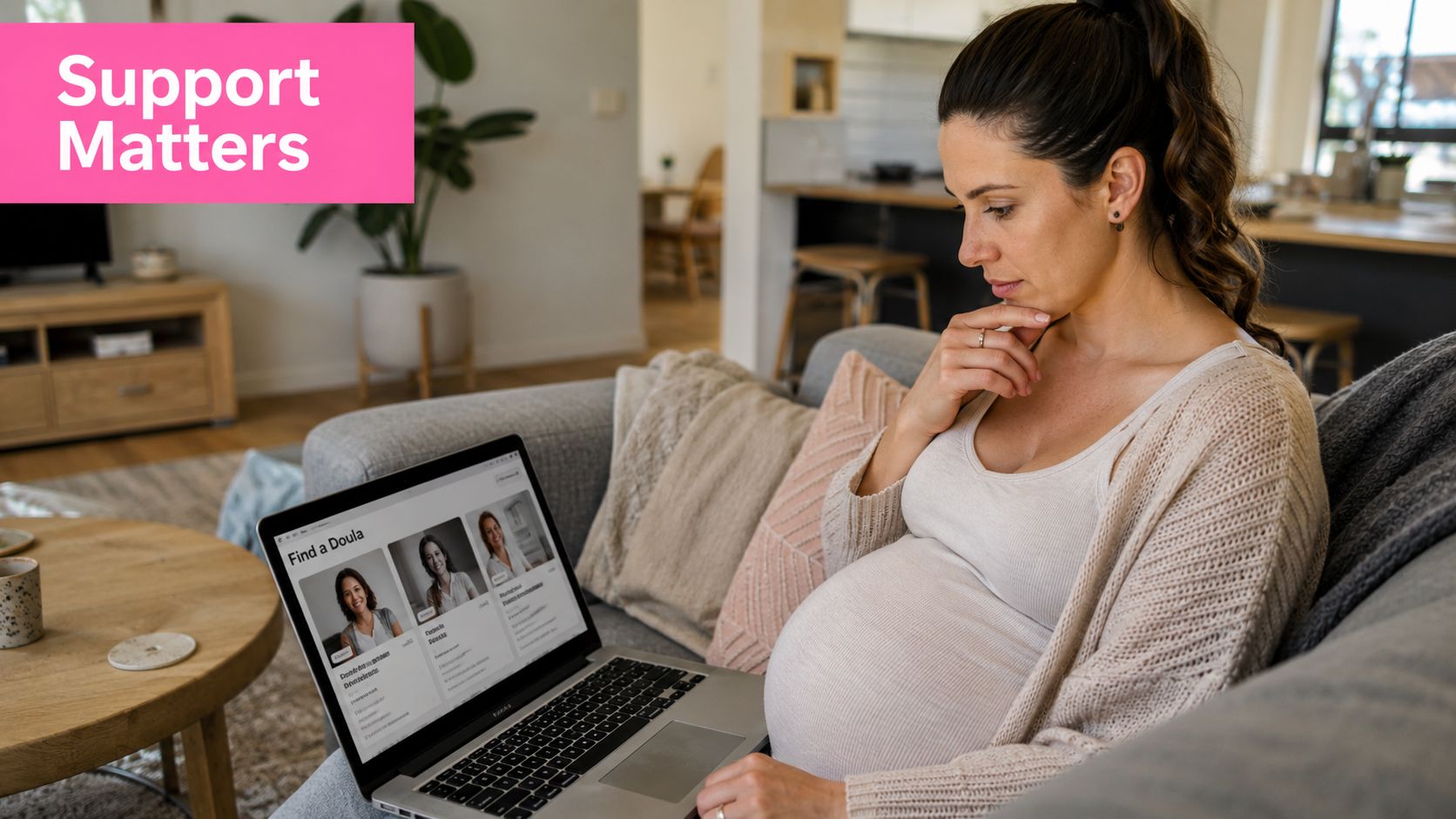 How to Find a Doula in Australia 2 A pregnant woman sitting on a couch, thoughtfully looking at a find a doula website on her laptop.